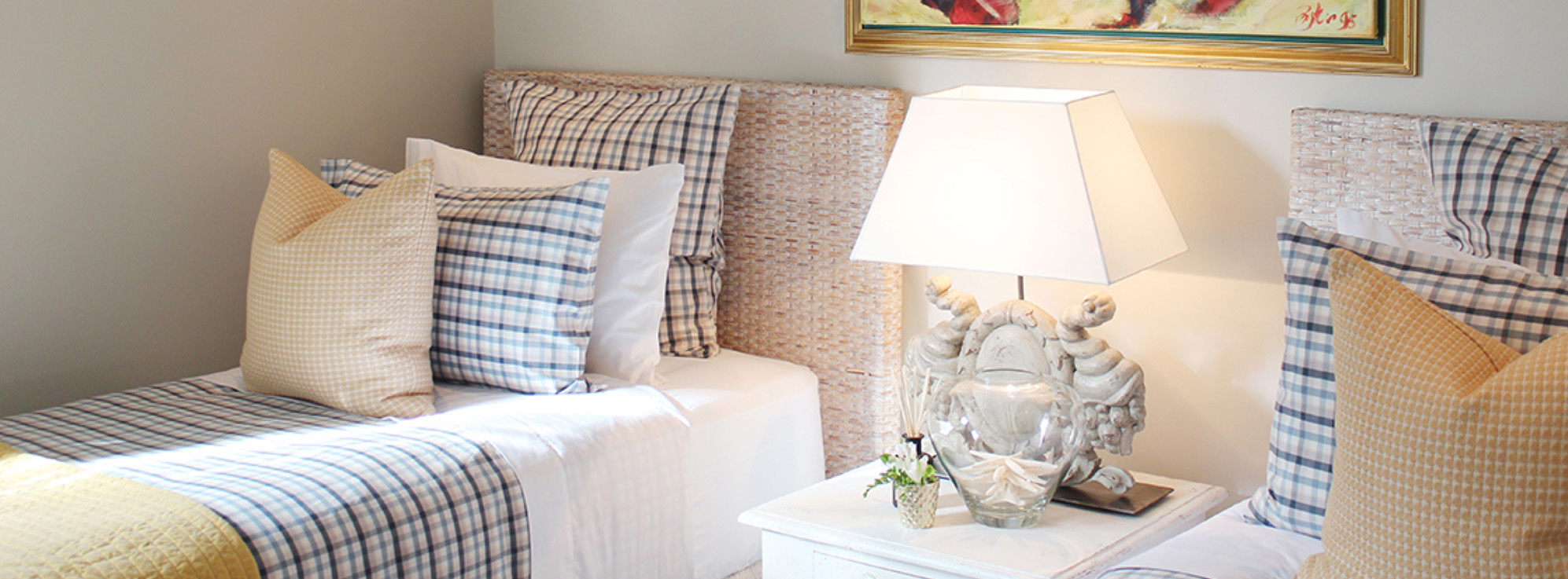 Twin Share Guest Bedroom Styling - Luxury Linen, Cane Bedhead & Designer Bedside Lamp | Point Residence Auckland Accommodation